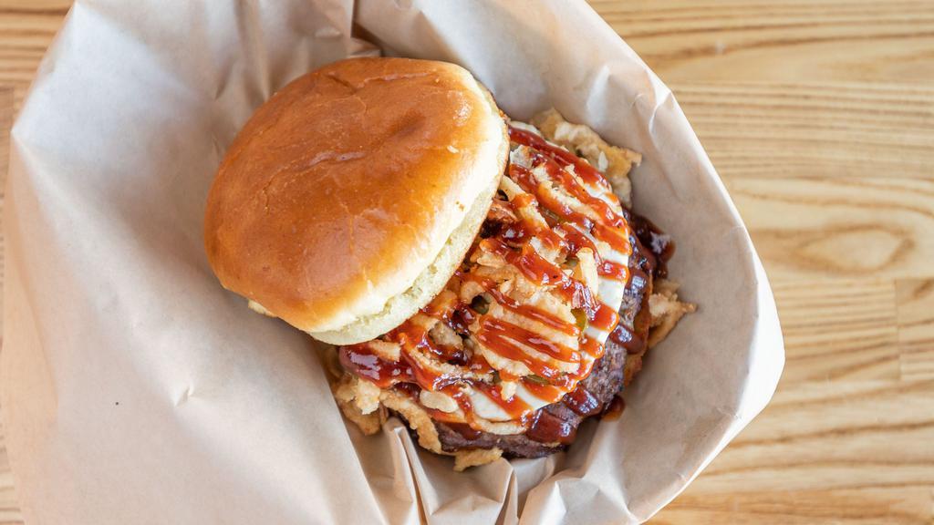 Jalapeño Popper Burger · A favorite snack done right! A generous portion of cream cheese spread, sautéed jalapeños, crispy French fried onions and our tangy BBQ sauce to top it off! Tip: it's even better with bacon.