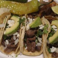 Texan Tacos (4) · Corn or flour tortilla tacos with your meat choice topped with fresh avocado, queso fresco, ...