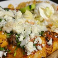 Taco Al Carbon (3) · Grilled corn tortillas in red sauce tacos filled with your choice of meat, topped with queso...