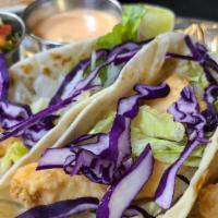Baja Fish Tacos (3) · Corn or flour tortilla tacos filled with grilled or house battered fried fish, topped with a...