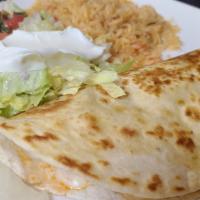 Quesadilla Rellena · Grilled flour tortilla filled with choice of shredded beef or chicken and melted cheese. Ser...