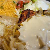 Pollo Asado · Marinated and seasoned chicken breast topped with grilled onions and cheese sauce. Served wi...