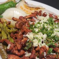 Pastor Especial · Grilled al pastor meat with onions & pineapple chunks on a skillet, served with 3 corn or fl...