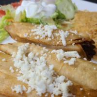 Flautas · Three crispy chicken flautas topped with lettuce, sour cream, tomatoes, queso fresco, served...