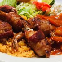 Camarones Rellenos · Shrimp stuffed with cheese and rolled with bacon. Includes rice and salad.