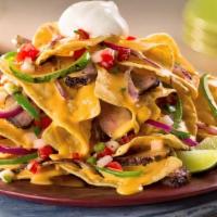 Nachos Grilled Fajitas · Corn tortilla chips served with beef or chicken, cheese, bell peppers, onions, and tomatoes.