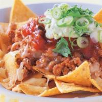 Nachos W/Chicken · Nachos, Chicken cooked with tomatoes and onions, topped with Cheese