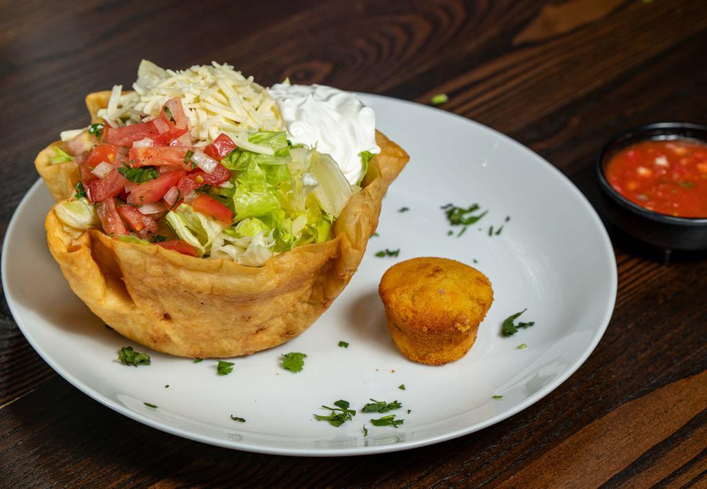 Taco Salad · Crispy flour shell tortilla with beef or chicken and beans, lettuce, tomatoes, cheese, sour cream, and guacamole.