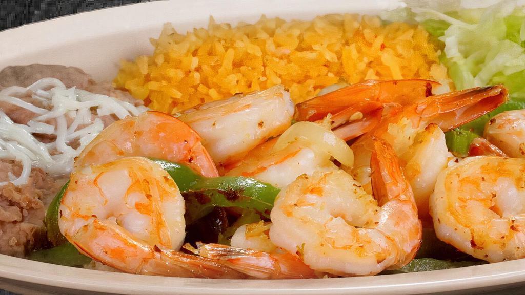 Shrimp Fajitas · Tender shrimp with bell, peppers, onions, guacamole, cheese, tomatoes, rice, beans, salad, and flour or corn tortillas.