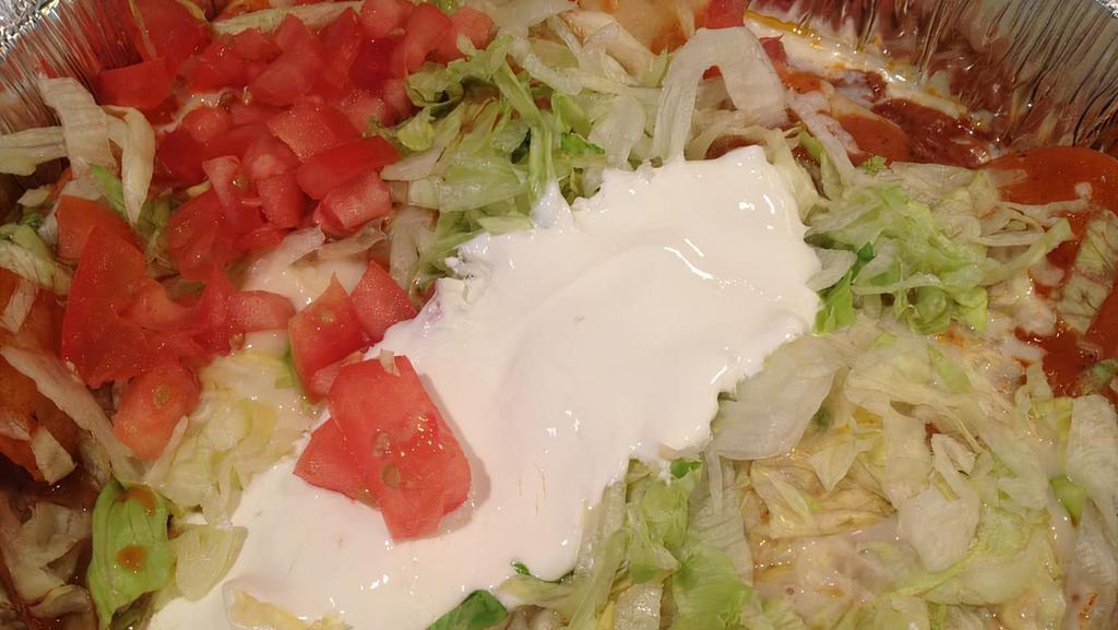 Enchiladas Supremas · Supreme combination consisting of one chicken, one bean, one cheese, and one beef enchilada. Topped with red sauce, lettuce, tomatoes, shredded cheese, and sour cream.