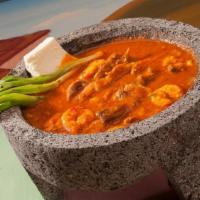 Molcajete · Spicy. Grilled steak, chicken, chorizo and shrimp sautéed in a special hot sauce, garnished ...