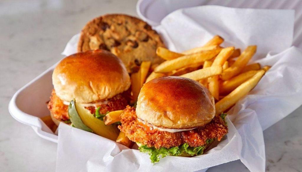 Fried Chicken Sliders Duo · 2 pieces of all white meat chicken coated in seasoned breading and fried crispy, topped with shredded lettuce, garlic aioli, sriracha maple glaze and pickles.