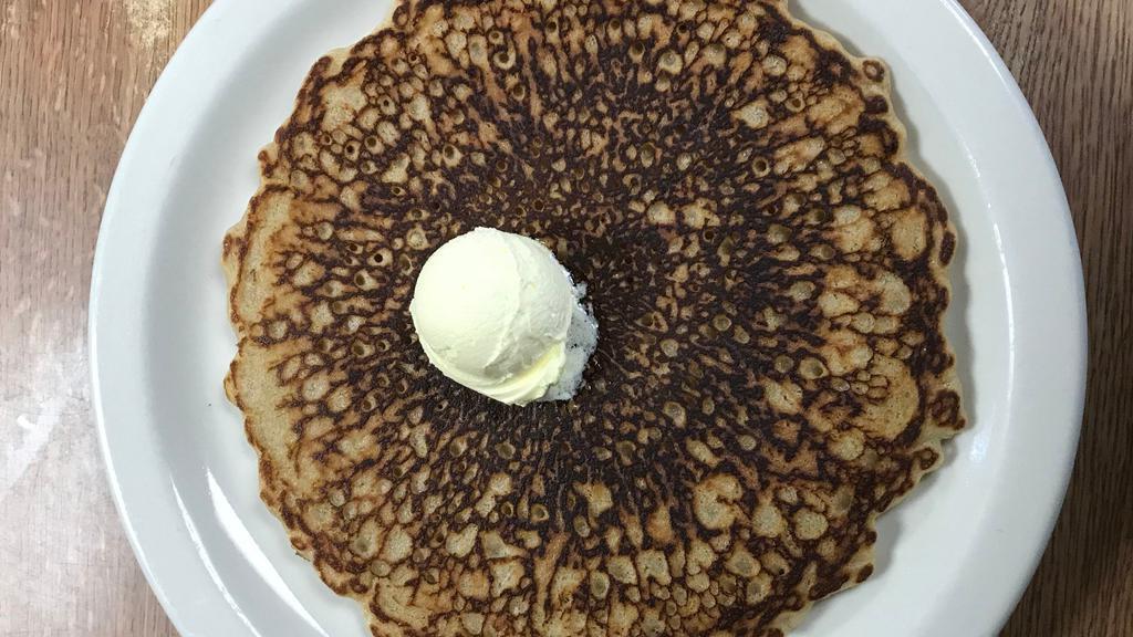 Single Pancake · 1 fluffy pancake topped with butter and powdered sugar. served with syrup.