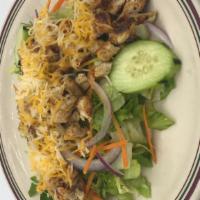 Grilled Chicken Salad · Tender juicy pieces of grilled chicken chopped and served atop a fresh bed of chopped lettuc...