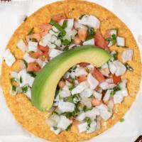Ceviche Tostadas · A crisp corn tortilla topped with a mix of raw fish, onion, jalapenos, tomatoes, cilantro, a...