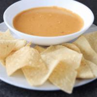 Chile Con Queso Small · Savory melted cheese, spiced with chile peppers and Tumbleweed seasonings. Served with corn ...