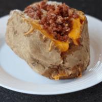 Loaded Baked Potato · Baked potato loaded with  bacon, cheese, butter and sour cream.