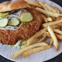 Lunch Pork Tenderloin Sandwich · Fried pork tenderloin topped with fresh lettuce, onion and pickles on a toasted bun, with pe...