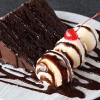 Mile High Chocolate Cake · Indulge yourself with a slice of our rich and delicious 5 layer chocolate cake. Served with ...