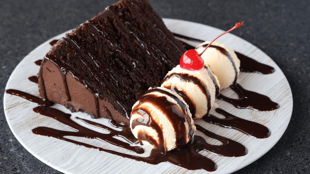 Mile High Chocolate Cake · Indulge yourself with a slice of our rich and delicious 5 layer chocolate cake. Served with vanilla ice cream.