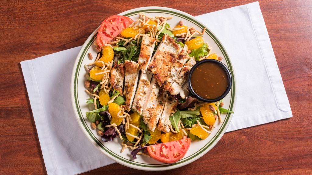 Oriental Grilled Chicken Salad · Mixed greens, mandarin oranges, peanuts and Chinese noodles topped with grilled chicken breast, served with Asian peanut dressing.