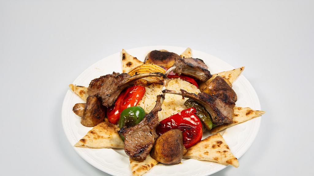 Lamb Chop Kebab · Grilled green peppers, red peppers, mushrooms, onion, 4 pieces of Lamb Chops, served with rice or fries.  Large house sauce and pita.