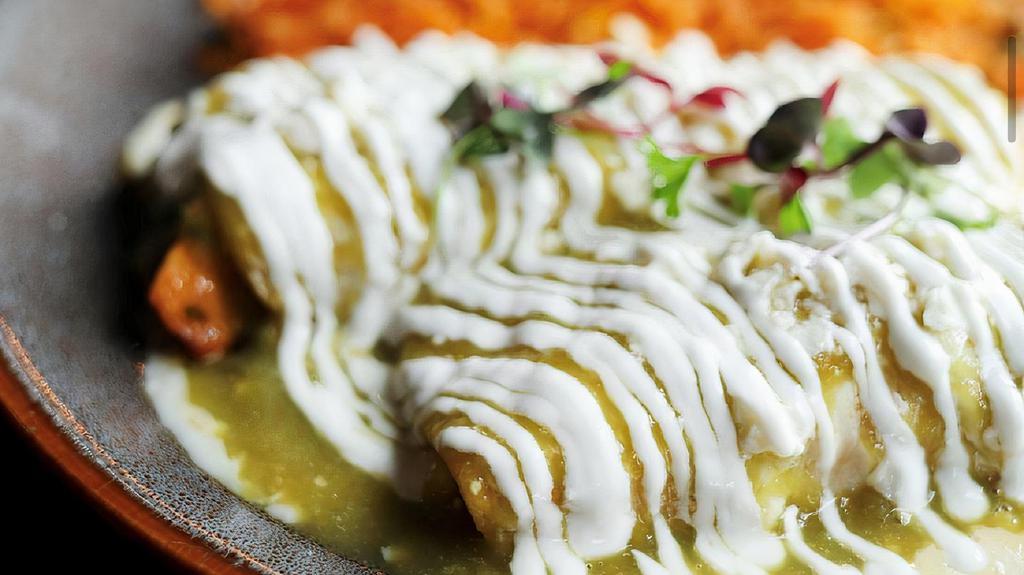Enchiladas Suizas  · Corn tortilla filled with grilled chicken / green tomatillo sauce /. sour cream / salad /. rice