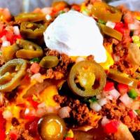 Nachos · Tortilla chips topped with grilled chicken, pulled pork or ground beef, cheese sauce, pico d...