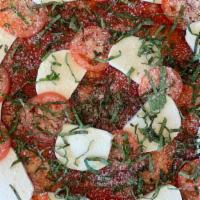 Margherita · Tomato sauce, fresh mozzarella, fresh basil, roma tomatoes, Parmesan.