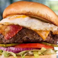 Hangover Burger · Topped with cheddar, smoky bacon, and a freshly fried egg, served atop shredded lettuce, tom...