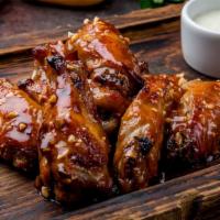 Bbq Wings · Golden, crispy fried wings tossed in sweet and smoky BBQ sauce. Your choice of Bleu Cheese o...