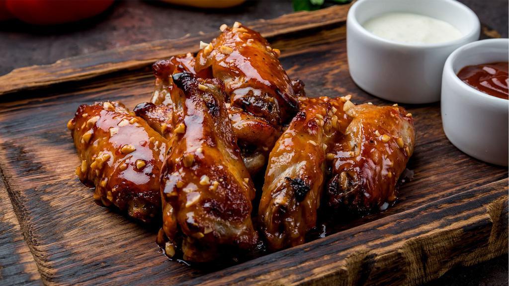 Bbq Wings · Golden, crispy fried wings tossed in sweet and smoky BBQ sauce. Your choice of Bleu Cheese or Ranch dippin' sauce.