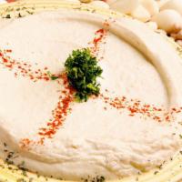 Hummus · Ground pureed chick peas blended with tahini, lemon, & garlic. Served with fresh bread.