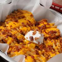  Sloppy Waffle Fries · Our famous waffle fries covered in cheddar cheese sauce, bacon and topped with sour cream.