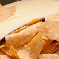 Our Famous Cheese Dip & Chips · Creamy dip made from melted cheese.