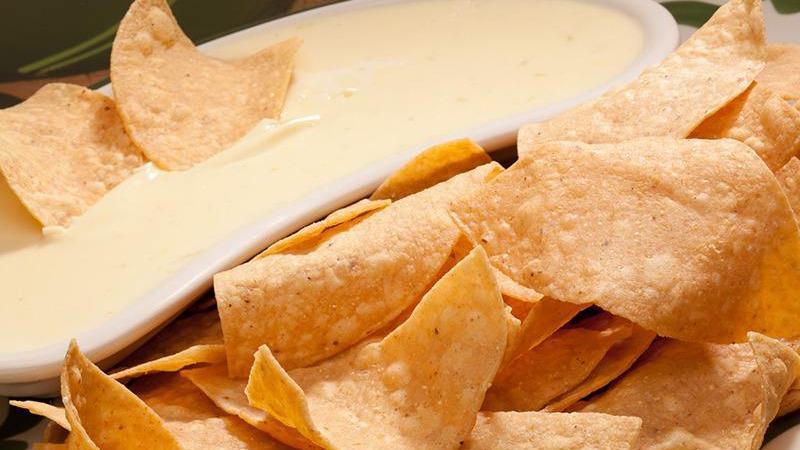 Our Famous Cheese Dip & Chips · Creamy dip made from melted cheese.