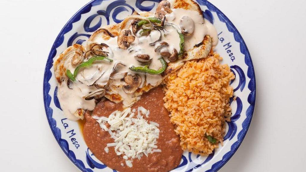 Pollo A La Crema · Grilled chicken breast with sautéed green peppers, mushrooms, and onions. Topped with a creamy chipotle sauce. Served with rice and refried beans.