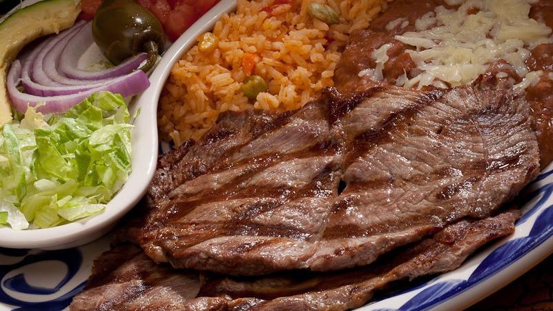 Carne Asada · Our grilled steak served with avocado, lettuce, tomato, jalapeño, red onions and served with 2 sides and tortillas.
