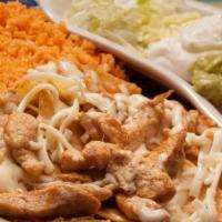 Chilaquiles Mexicanos · Spicy. Our traditional chips mixed with grilled chicken or steak, topped with melted cheese ...