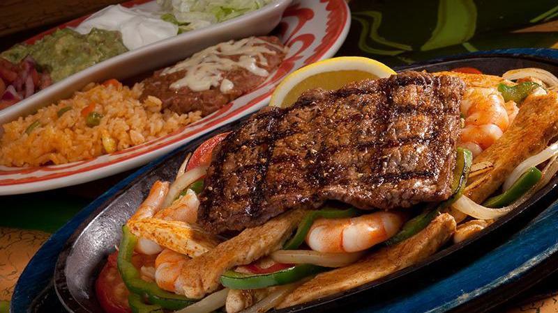Especial De La Mesa For Dos · Chicken, shrimp and chorizo fajitas topped with carne asada.