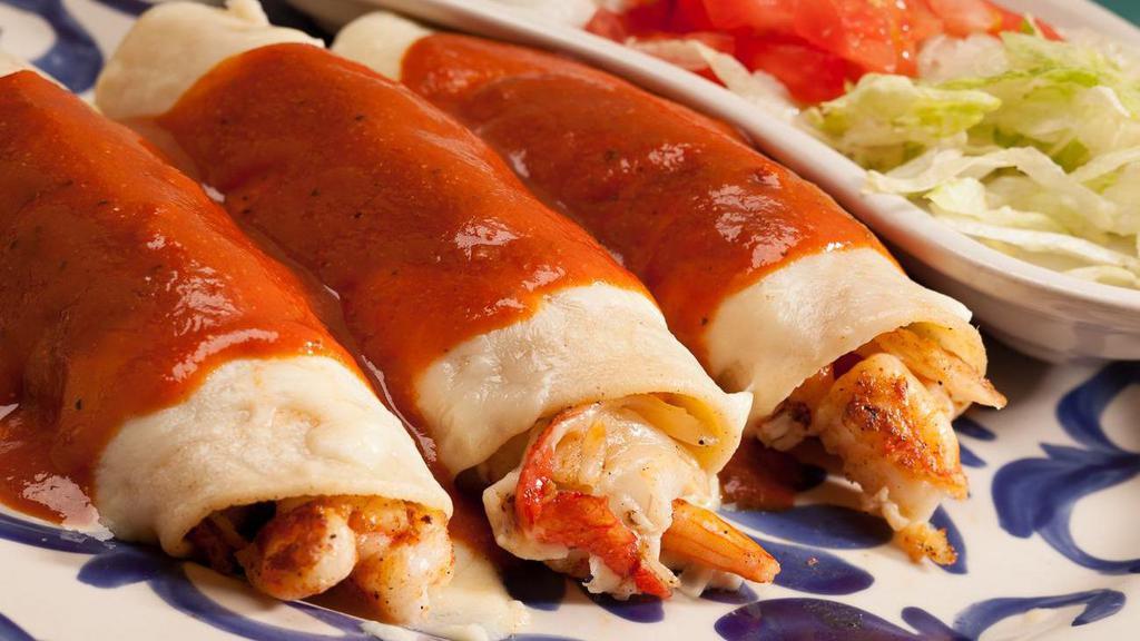 Enchiladas Acapulco · Three enchiladas filled with shrimp and crab, topped with melted cheese and sauce. Served with rice, lettuce, tomato, and sour cream.