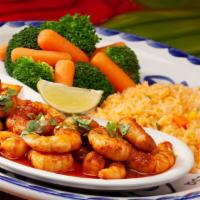 Camarones Al Tequila · New. Spicy. Seasoned shrimp sautéed in a butter chipotle sauce and flamed tequila. Topped wi...