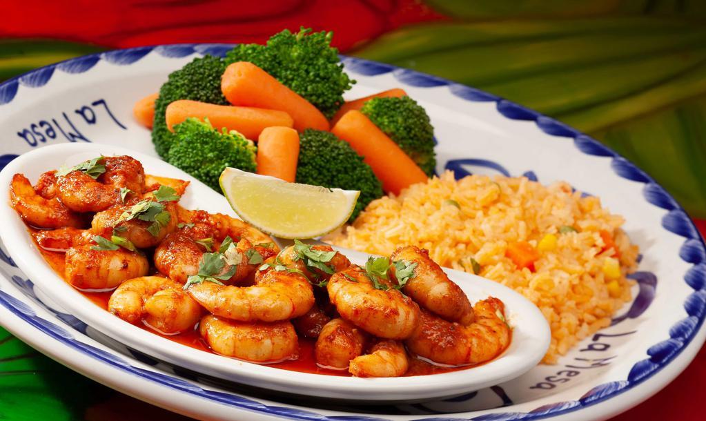 Camarones Al Tequila · New. Spicy. Seasoned shrimp sautéed in a butter chipotle sauce and flamed tequila. Topped with cilantro and lime. Served with rice and steam vegetables.