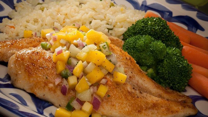 Mango Fish · Grilled tilapia grilled with olive oil, topped with fresh mango salsa. Served with rice and your choice of steamed vegetables or house potatoes.