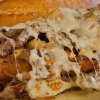Steak Sandwich · Thinly sliced fresh butchered ribeye, caramelized onions and mushrooms topped with mozzarell...