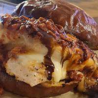 Pesto Chicken Sandwich · Contains nuts. Grilled chicken, pesto, mozzarella, marinara and balsamic glaze on a pretzel ...