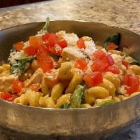 Cajun Chicken Pasta · Cavatappi pasta tossed with grilled chicken, spinach and tomatoes then covered in Cajun Alfr...