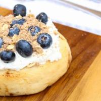 Blueberry Pie Cinnamon Roll · Cream cheese frosting w/ blueberries and pie crumble