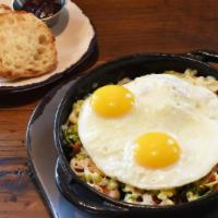 Sweet Potato Skillet · Sweet potatoes, shaved Brussel sprouts, bacon, apple and Mozzarella cheese, topped with two ...