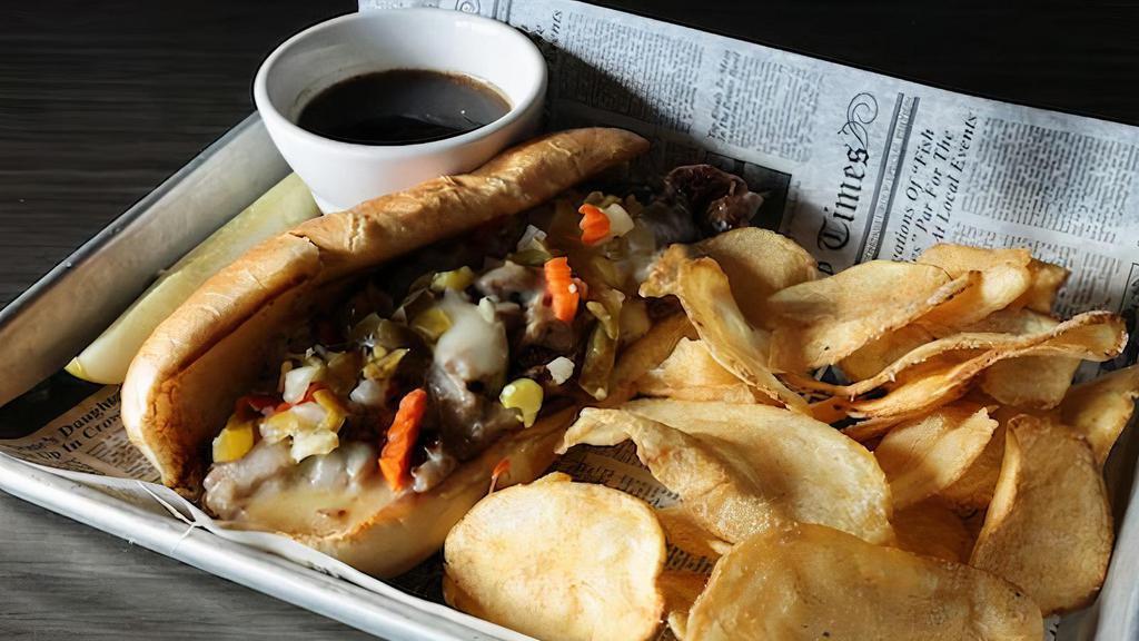 Italian Beef Sandwich · Carved prime rib, mild giardiniera peppers, provolone cheese, served with au jus on a hoagie bun.
